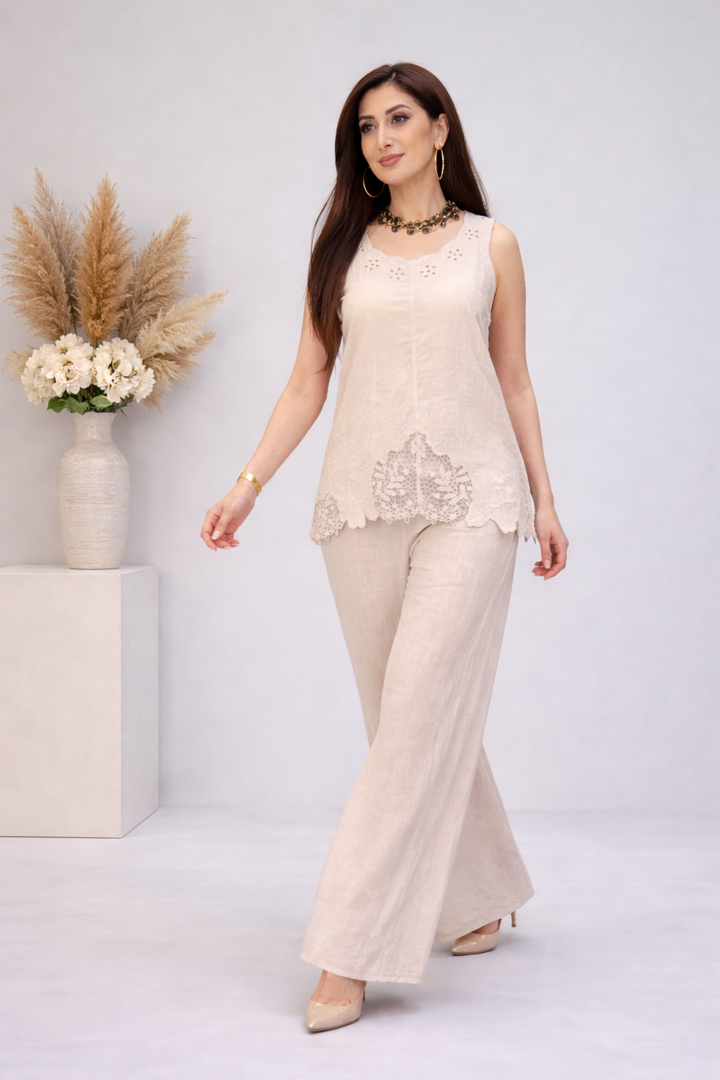 Elegant woman in chic beige linen outfit — studio portrait